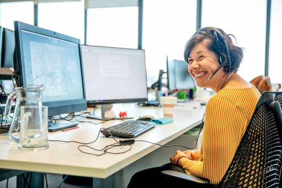 Lady smiling at work desk