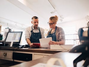 Man and woman discussing paperwork